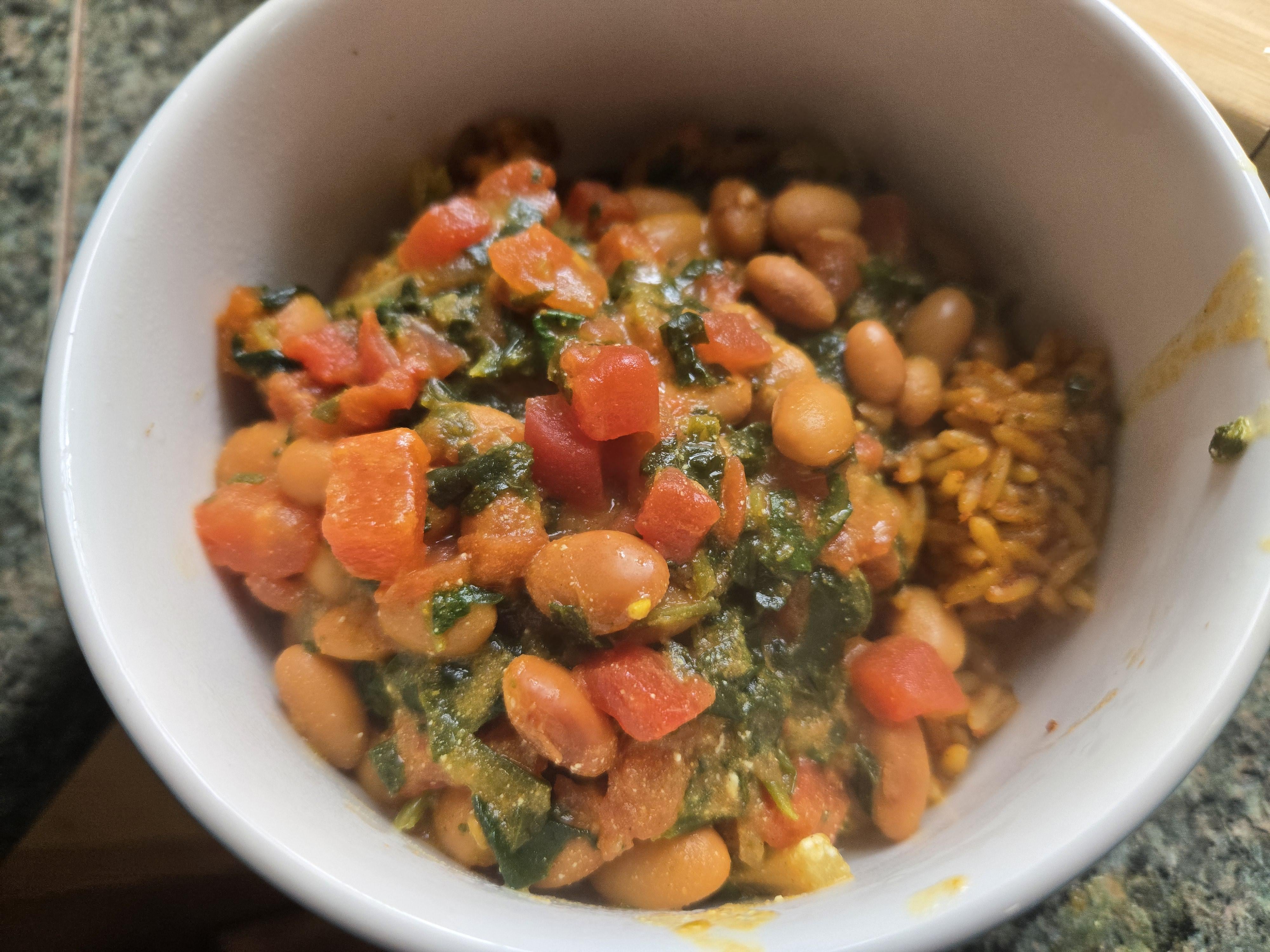Vegan struggle meal, curried pinto beans and spinach on microwave rice
