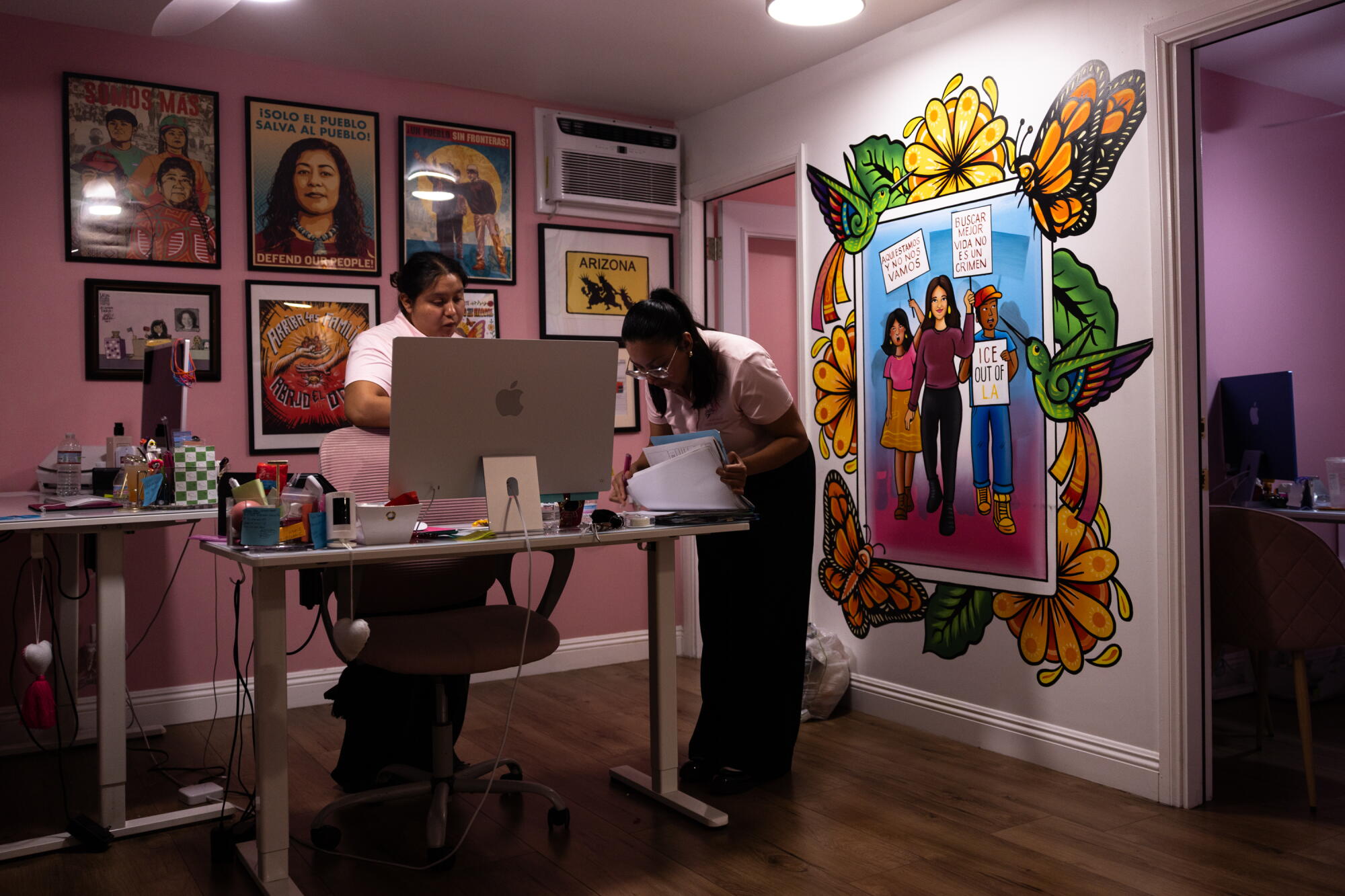 Maria Xivir and Liliana Ibanez, both assistants to immigration attorney Karla Navarrete, work in her office.