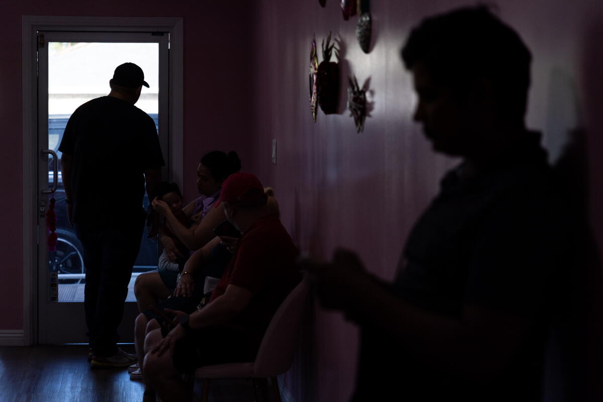 People wait at the office for Monday night free consultations.