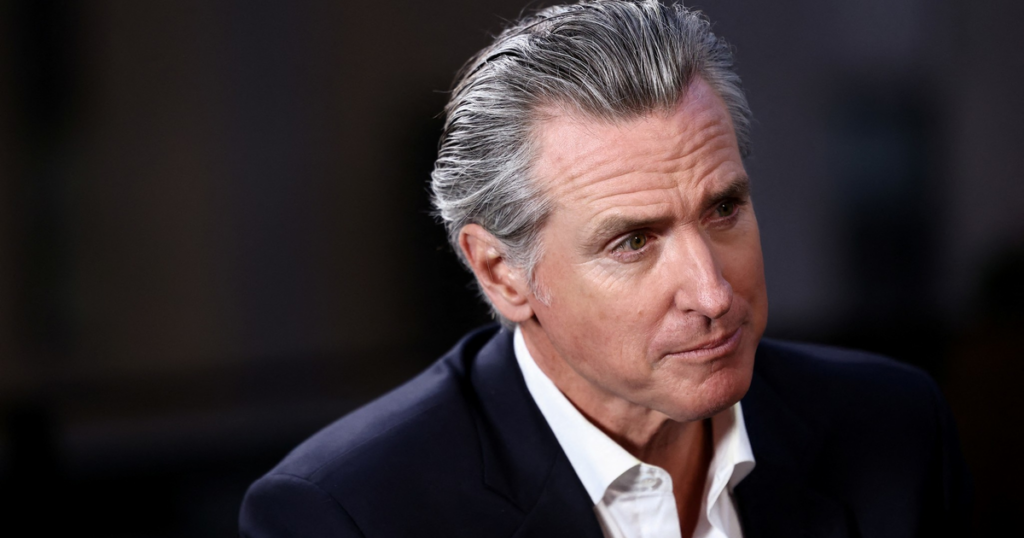 Newsom’s do-over on sober housing could help erase a 2028 campaign liability A middle-aged man with slicked-back gray hair wears a dark suit jacket and a white shirt, looking thoughtfully to his right.