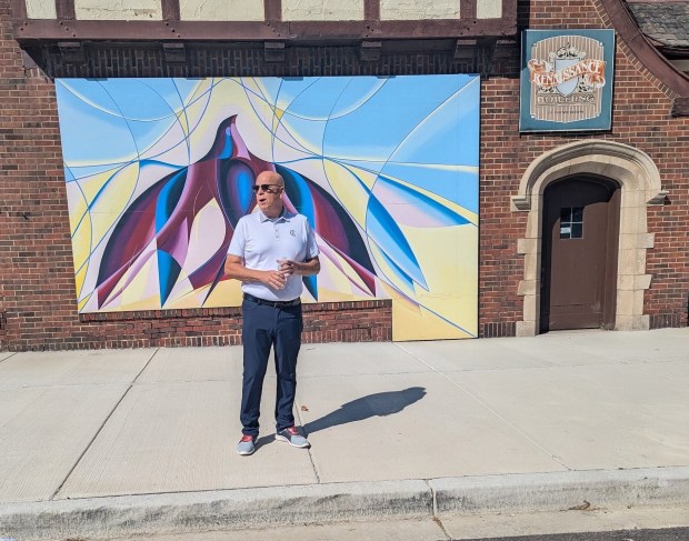 Chicago Heights Mayor David Gonzalez speaks about revitalization efforts along Otto Boulevard during the Aug. 22 unveiling of a large new mural across the street from Union Street Gallery in Chicago Heights. (Janice Neumann/Daily Southtown)