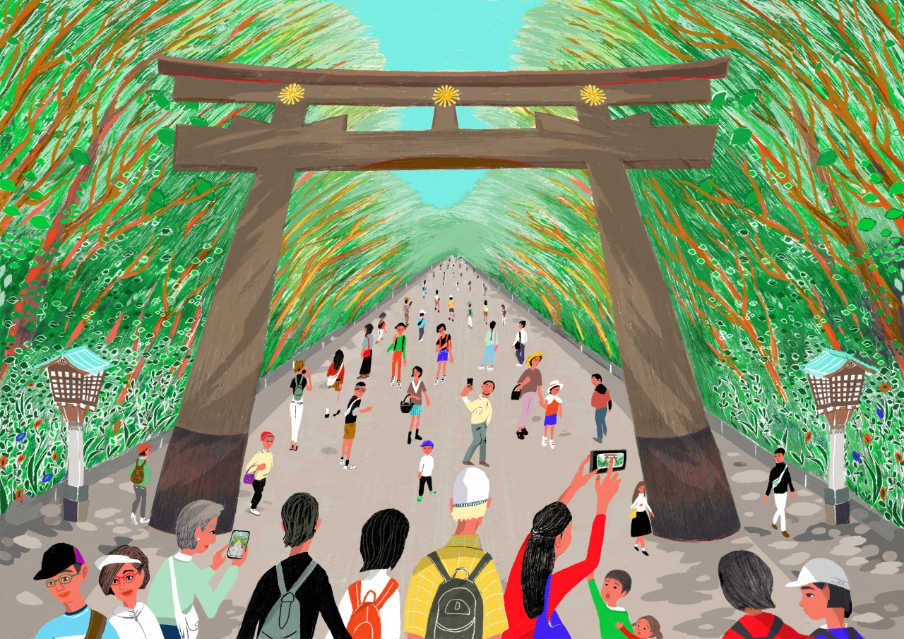 Crowds of visitors gather beneath a large wooden torii gate in a tree-lined avenue, with some taking photos and recording on their devices