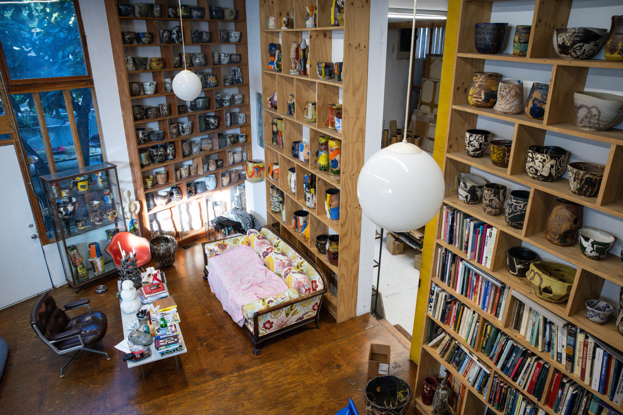 Roger Herman added large bookshelves in his studio to display his ceramics and expansive library.