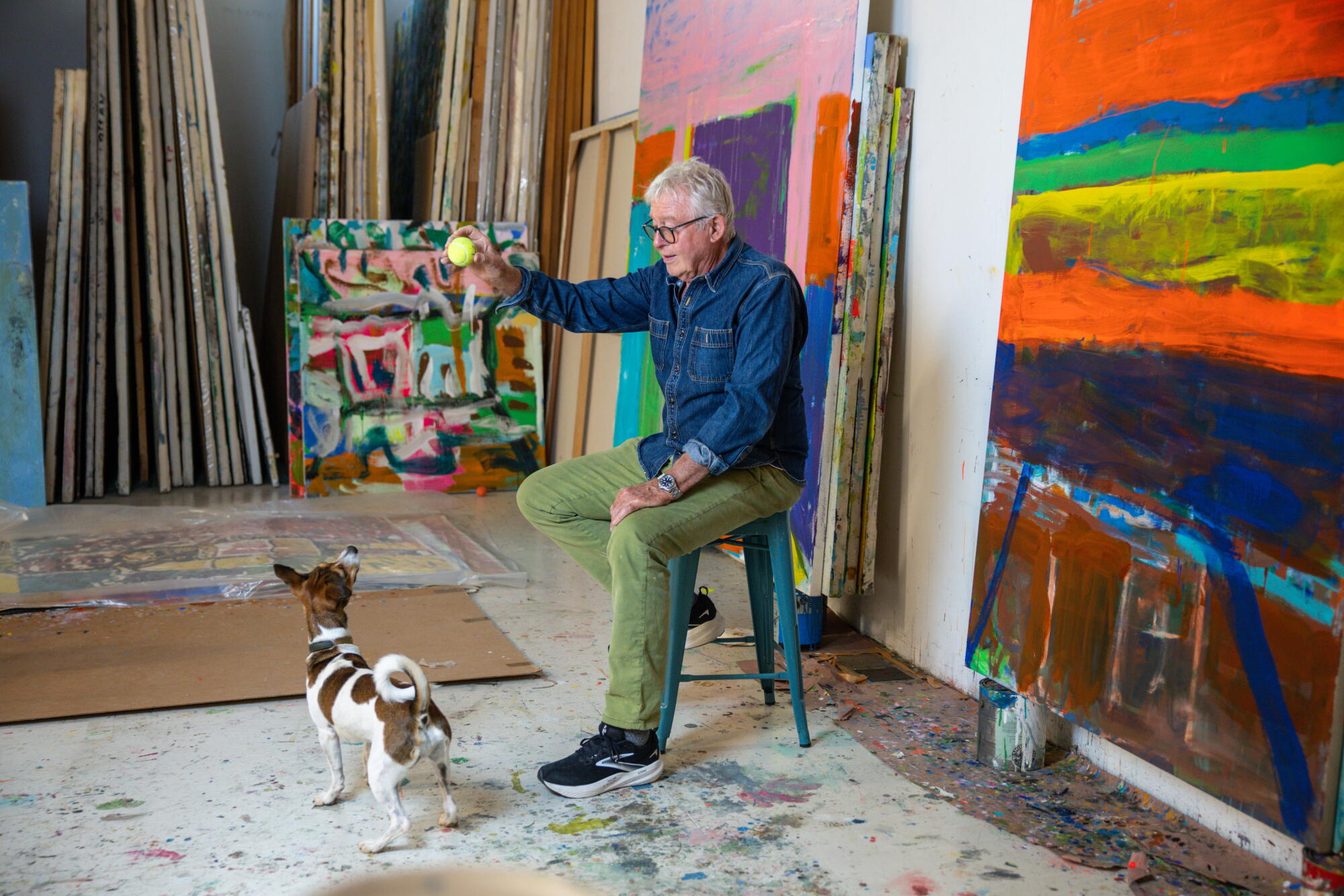 Roger Herman holds a ball while playing with his dog, Willy.
