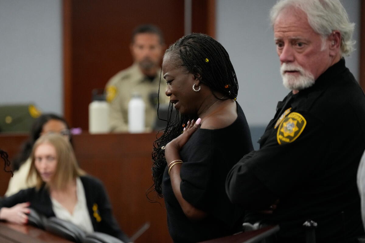 Sekyiwa "Set" Shakur, center, attends the trial of Duane Davis during a sentencing hearing