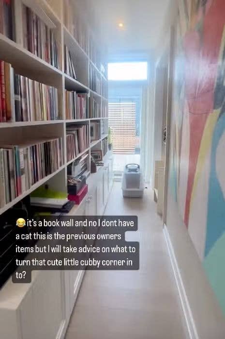 property corridor with colourful wall and wall of books