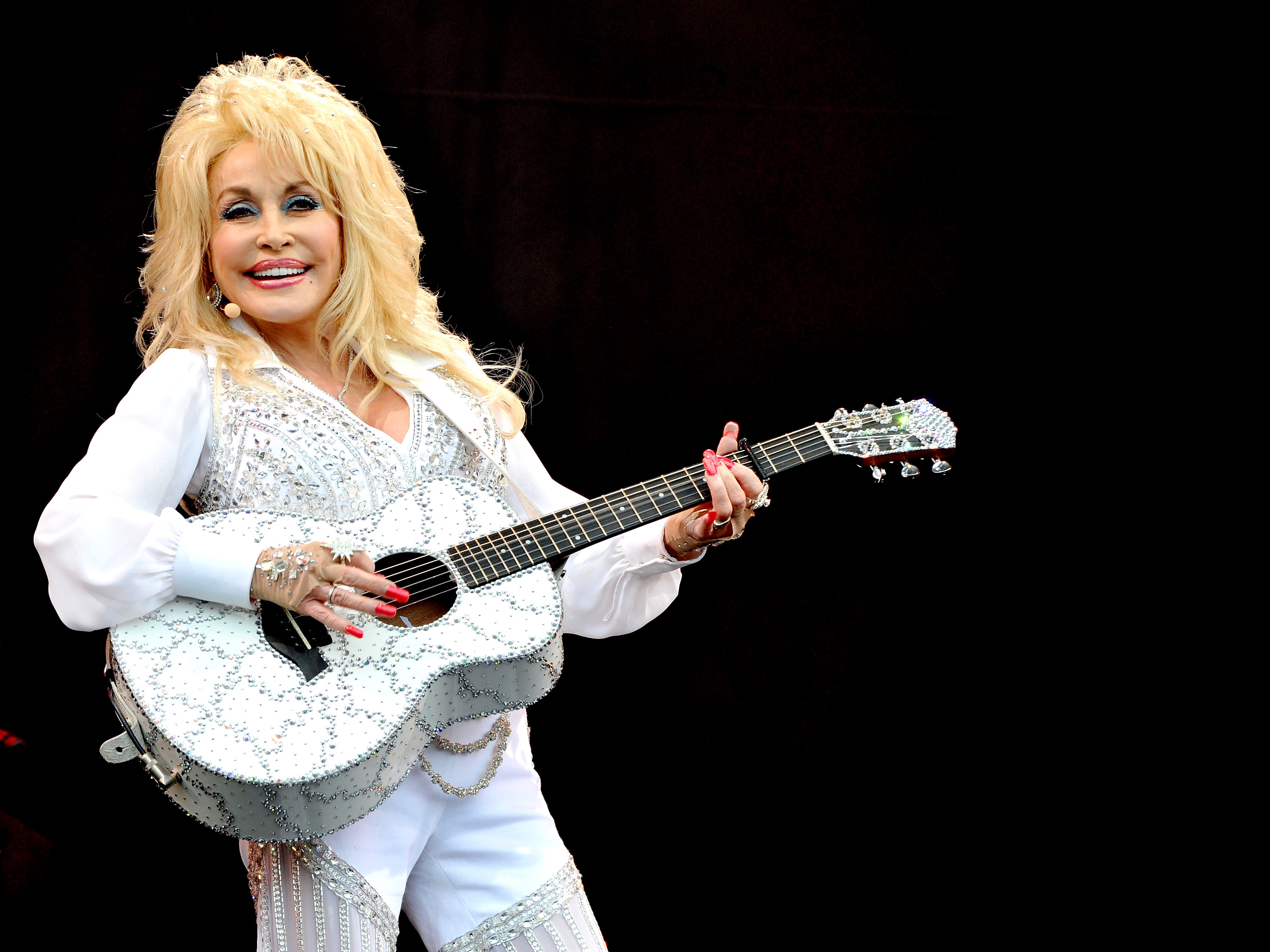 GLASTONBURY, ENGLAND - JUNE 29:  Dolly Parton performs on The Pyramid Stage on Day 3 of the Glastonbury Festival at Worthy Farm on June 29, 2014 in Glastonbury, England.  (Photo by Shirlaine Forrest/WireImage)
Day 3 - Glastonbury Festival