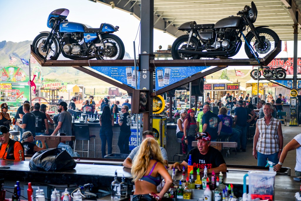 People sitting at the outdoor bars at the Full Throttle Saloon during the Sturgis Motorcycle Rally.